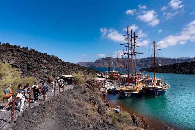 Santorini - Volcano and Hot springs Boat Trip with Bus Transfer - Volcano stop at Erinia: active craters, sulfur smell, and an uphill choice